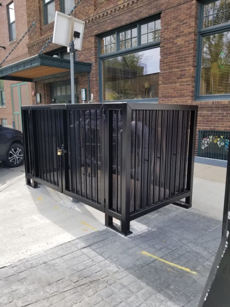 Custom fence railing protecting a sign